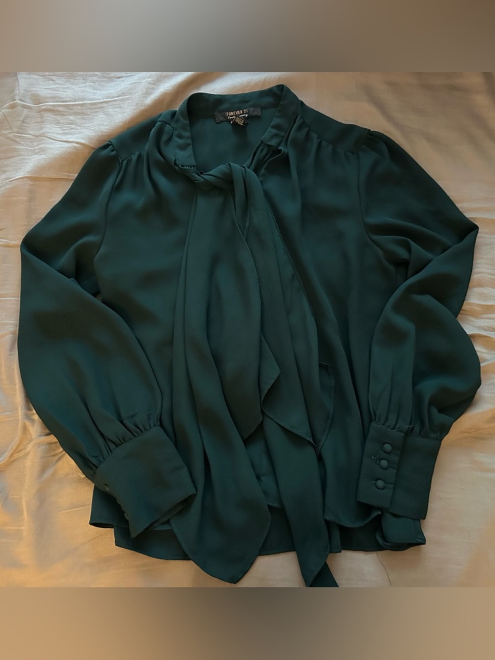 Emerald green blouse with necktie detail and button sleeves